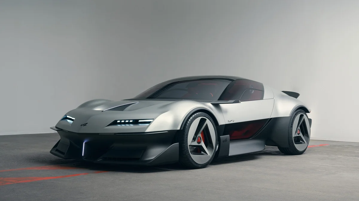 Zilvergrijze Alpine A310 VISION conceptauto van schuin voren in een lichte studio met rode lijnen op de vloer