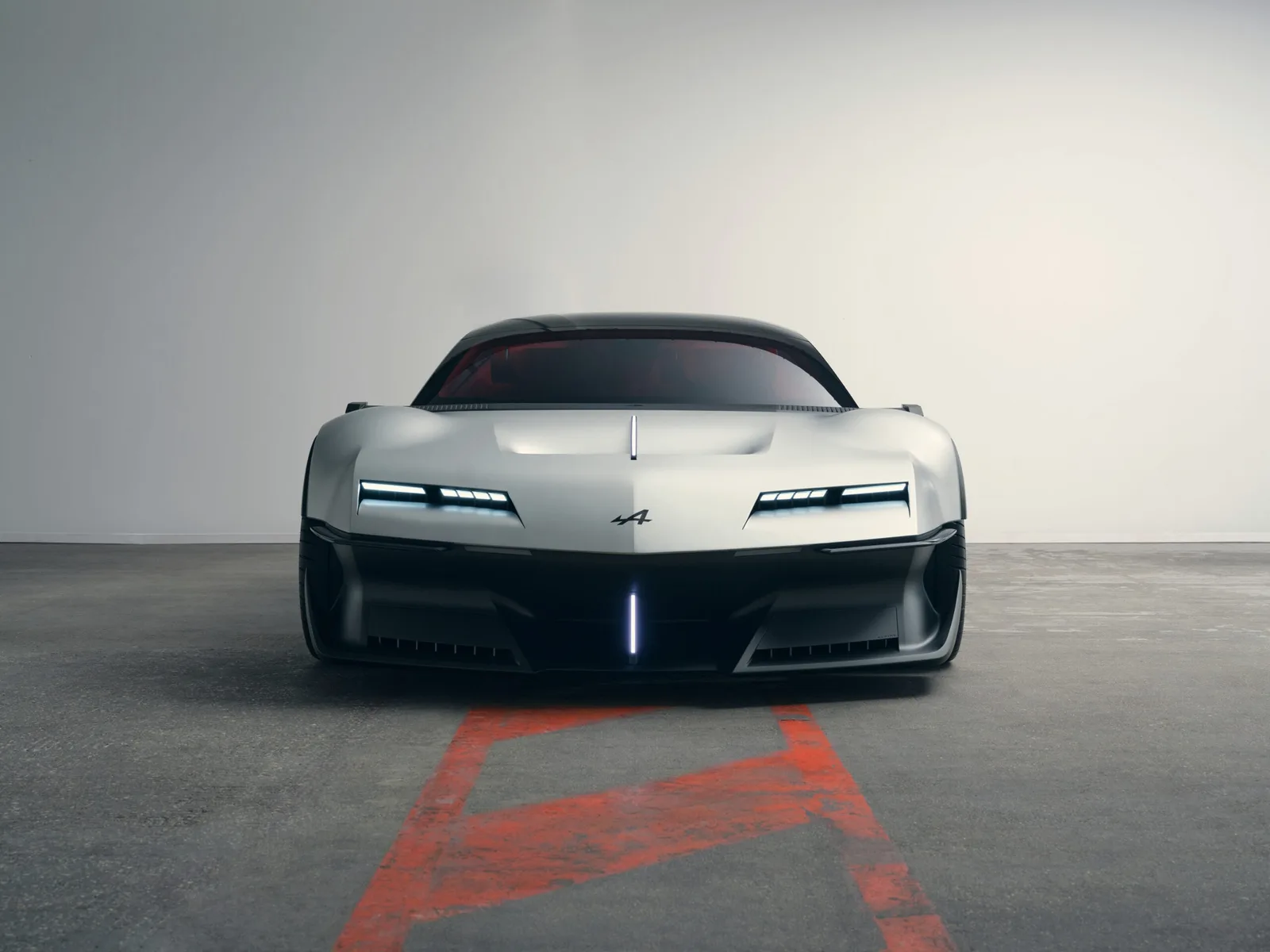Vooraanzicht van de Alpine A310 VISION met smalle verlichte koplampen en een verlichte streep in de bumper