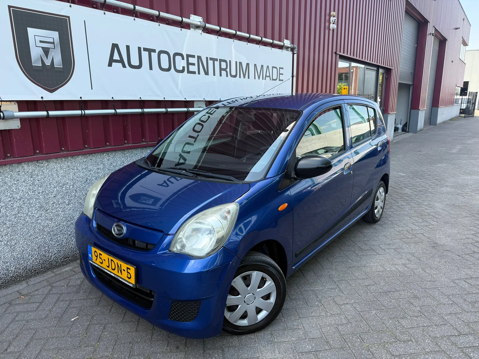 Daihatsu Cuore (2009) — foto 1