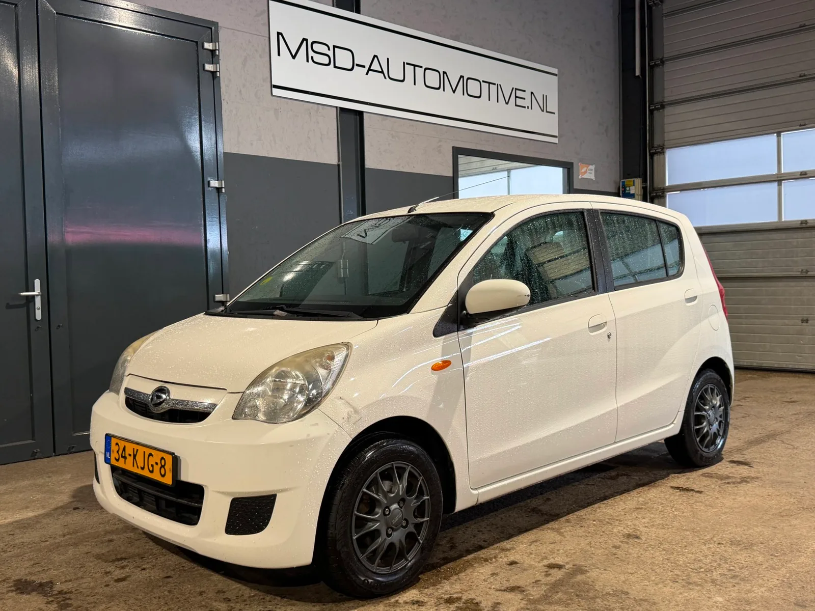 Daihatsu Cuore (2009) — foto 1